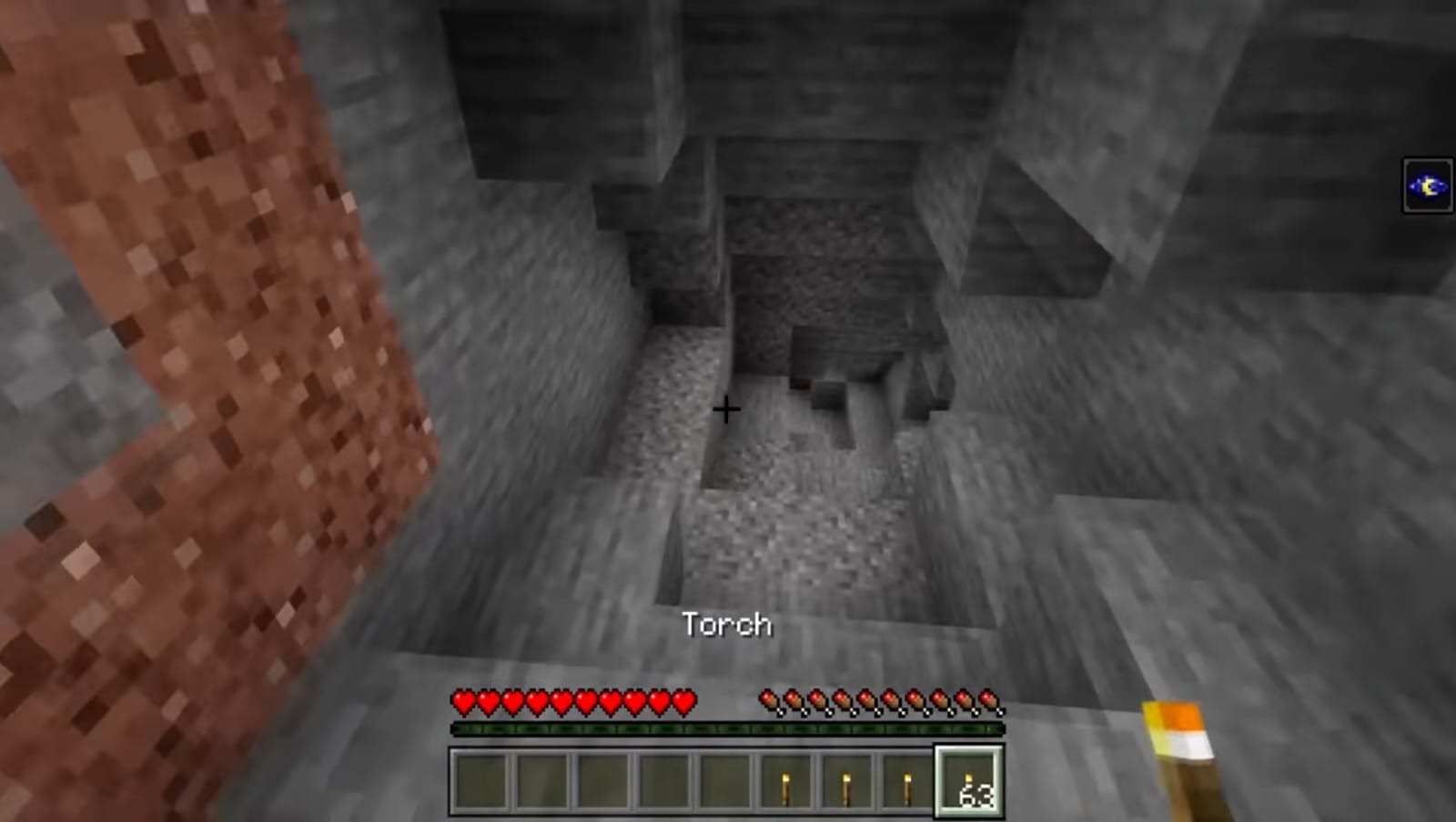 Handheld torch enlightening a dungeon of Minecraft 