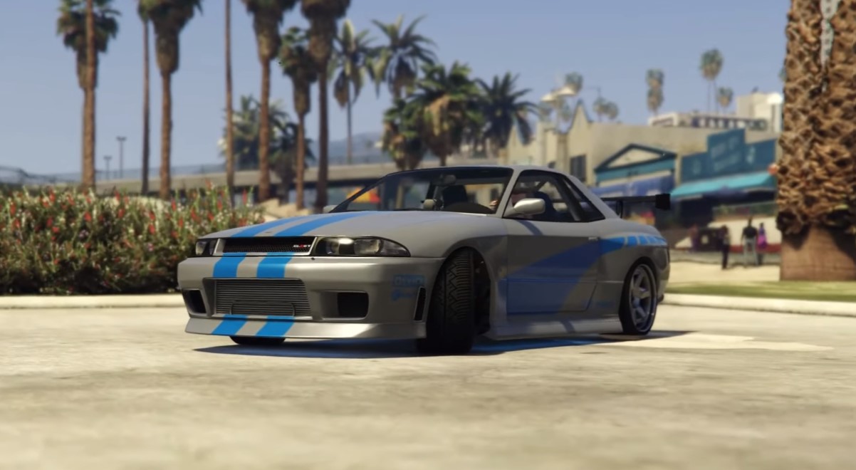 Brian O'Connor's Nissan Skyline GT-R R34. a grey car with a blue stripe at the hood