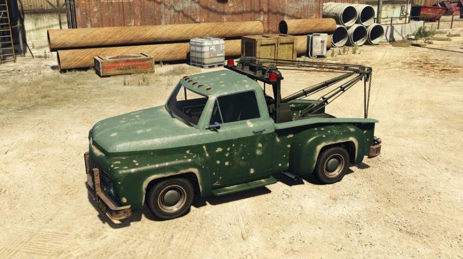 small green tow truck parked